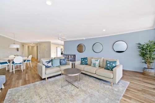 a living room with a couch and a table at Flightdeck 301 5-7 Clarence Street in Port Macquarie