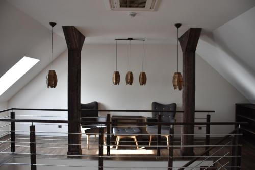 a dining room with two chairs and a table at Penzion Víno Hruška Blatnička in Blatnička