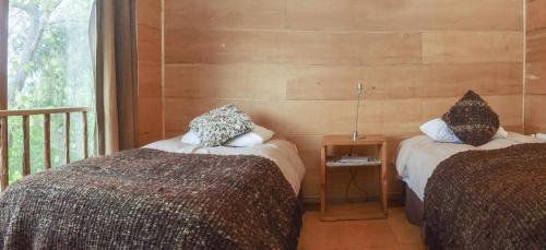 Un pat sau paturi într-o cameră la Palafito Cucao