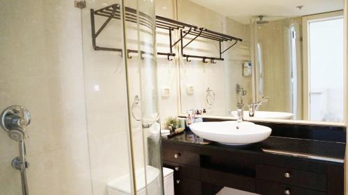 a bathroom with a toilet and a sink and a shower at Marina Towers - Herzeliya in Herzelia 