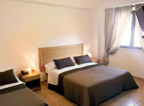 Llit o llits en una habitació de Albergo Villa Riccio
