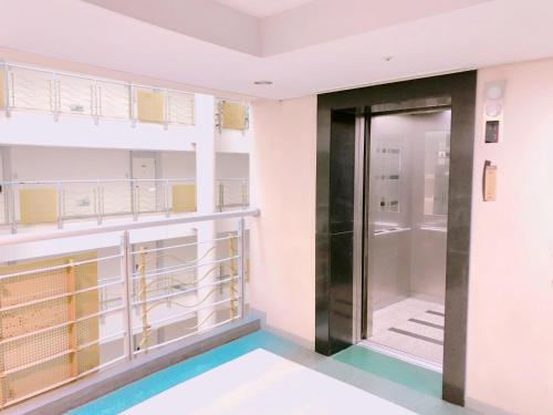 a hallway with a door in a building at Incheon Airport Guesthouse in Incheon