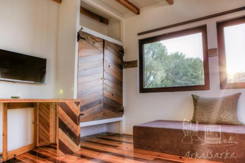 a living room with a large window and a couch at ArkaBarka 2- Floating Dream Rooms and Apartments in Belgrade
