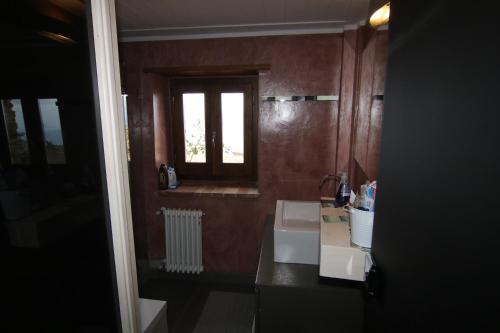 a bathroom with a sink and a window at Bed & Breakfast StudioArcodia- in San Marco dʼAlunzio