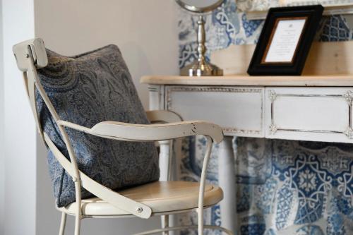 a chair sitting next to a desk in a room at Padstow Townhouse in Padstow