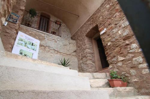 a stone building with some plants on the stairs at Bed & Breakfast StudioArcodia- in San Marco dʼAlunzio