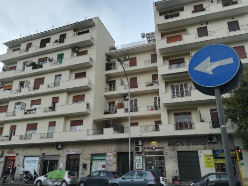 an apartment building with a blue sign in front of it at Enjoy Porta Furba in Rome