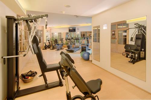 a gym with exercise equipment in a room at Majestic - Unique Spa Resort in Brunico