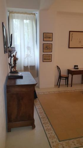 a living room with a table and a chair at Hotel Santa Marina Antica Foresteria in Santa Marina Salina