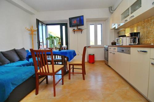 a living room with a kitchen and a table and chairs at Apartment Mambo in Sobra