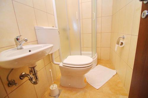 a bathroom with a toilet and a sink at Apartment Mambo in Sobra