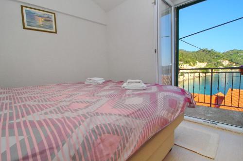 a bedroom with a bed and a large window at Apartment Mambo in Sobra