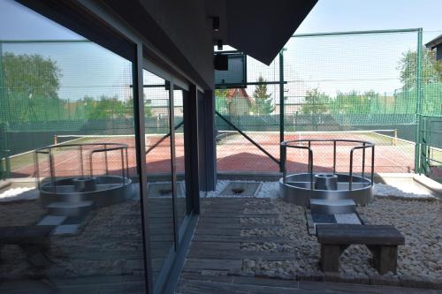 a view of a tennis court from inside a building at Penzion Víno Hruška Blatnička in Blatnička