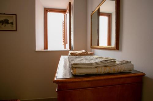 eine Kommode mit einem Handtuch und einem Spiegel in der Unterkunft Appartamento Piazza Pretoria in Palermo