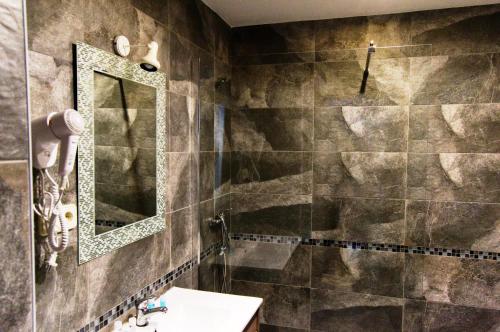 a bathroom with a sink and a mirror at Hotel Don Angel in Villanueva de la Cañada