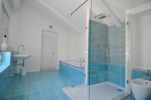 a bathroom with a glass shower and a sink at La Zinefra Amalfi Dreams in Minori
