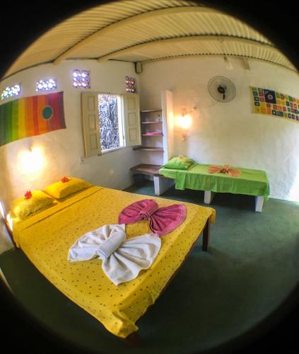 a bedroom with two beds with towels on them at Hostel Moreré in Moreré