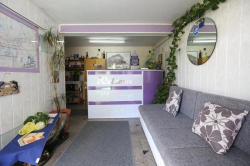 a living room with a couch and a mirror at Vila Marija sobe,wellnes ap već od 115eura in Zagreb