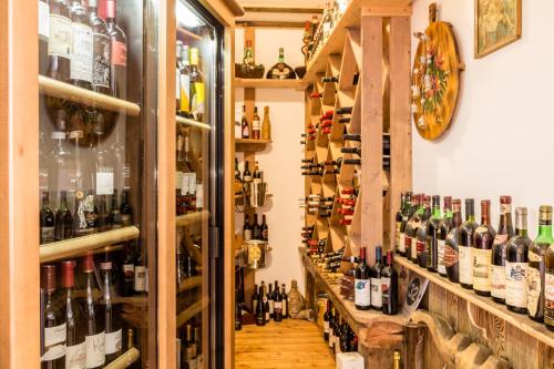 a room filled with lots of bottles of wine at Pineta Pastry Hotel in Rocca Pietore
