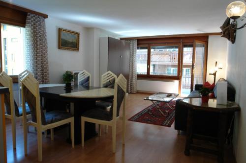 a kitchen and dining room with a table and chairs at Myzermatt Monazit in Zermatt