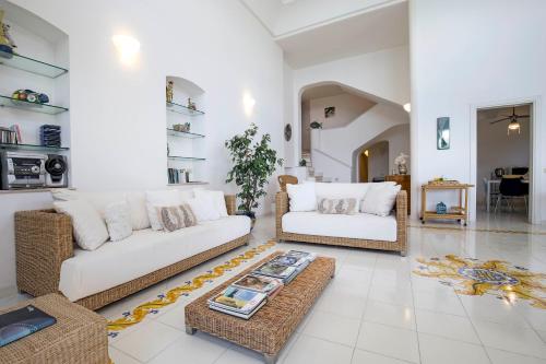 a living room with two couches and a coffee table at Villa dei Limoni con terrazza e discesa a mare in Erchie