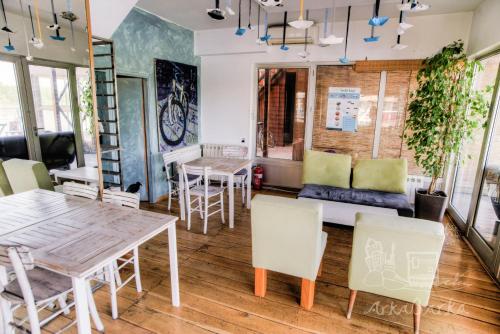 a dining room with a table and chairs at ArkaBarka Floating Hostel in Belgrade