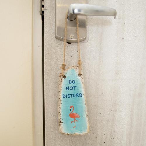 a do not disturb sign hanging on a door at Hotel Islander Bonaire in Kralendijk