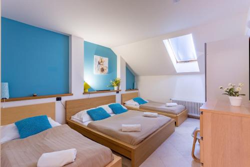 a bedroom with two beds with blue pillows at Legerova 33 Apartments in Prague