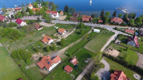 an aerial view of a village with houses and the water at Sterburta in Rydzewo