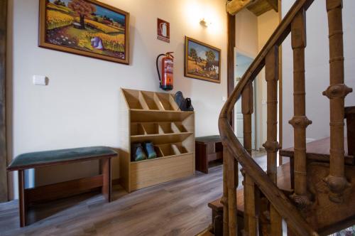 a living room filled with furniture and a stair case at La Casona de Sarria in Sarria