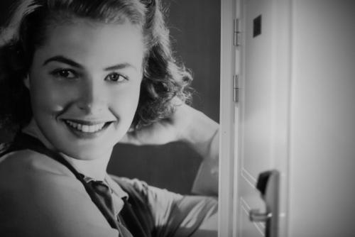a woman wearing a tie and smiling in front of a mirror at Castle House Inn in Stockholm