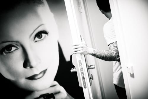 a woman is looking at a man through a door at Castle House Inn in Stockholm