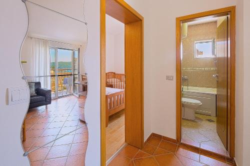 a view of a bathroom with a toilet and a balcony at Apartment Ivanovic Family in Becici