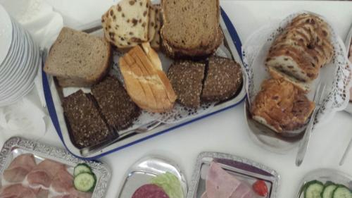 a table with a plate of bread and other foods at Hotel Fürstenberger Hof in Xanten