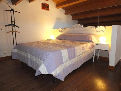 a bedroom with a bed and a table with lights at Tenuta Sperlinga - Il Campanile in Santa Flavia