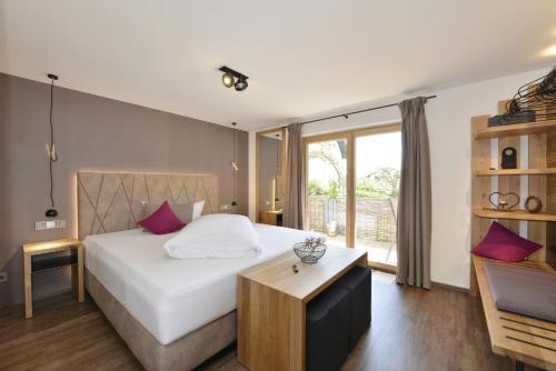 a hotel room with a bed and a table at Pension Waldkristall in Frauenau