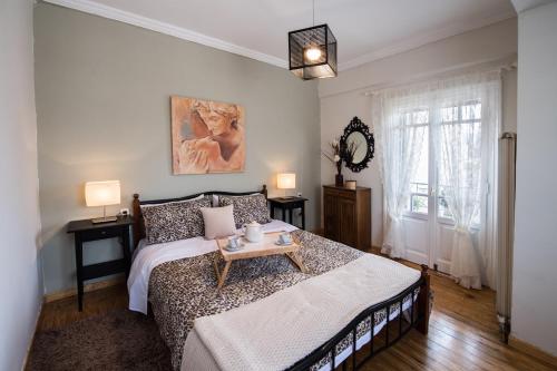 a bedroom with a bed with a table on it at La casa di Iro in Lefkada