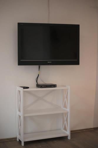 a flat screen tv on top of a white shelf at Pepi‘s Apartment in Hallstatt