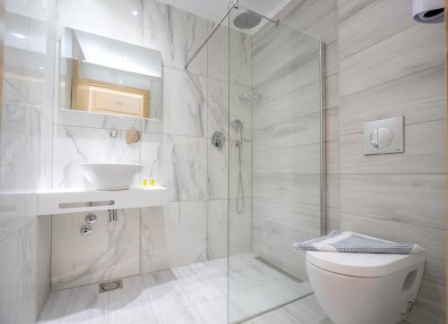 a bathroom with a shower and a toilet and a sink at Castello in Limenaria