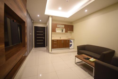 a living room with a couch and a table at Broad Almkan Apart Hotel in Taif