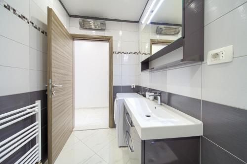 a bathroom with a sink and a mirror at Apartments VALL in Krk