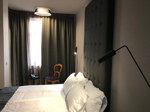 a bedroom with a bed and a lamp and a window at Design Hotel 36 in Sofia