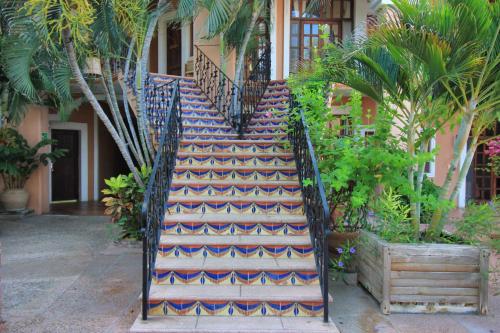 a staircase in a building with a patterned carpet at Hotel Santa Fe in Puerto Escondido