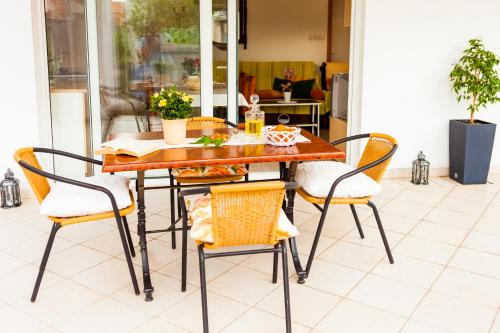 a dining room table and chairs on a patio at Guest House Mara in Vela Luka