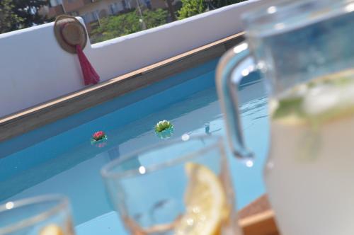 a window sill with a glass with a lady bug on it at Villa Imerti Kiotari in Kiotari