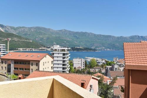 a view of a city with mountains and a body of water at Apartments Jelušić in Budva
