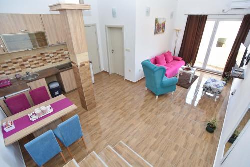 an overhead view of a living room with pink and blue chairs at Apartments Jelušić in Budva