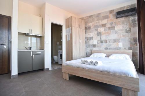 a bedroom with a bed with towels on it at Apartments Jelušić in Budva