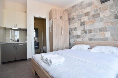 a bedroom with a large bed with towels on it at Apartments Jelušić in Budva