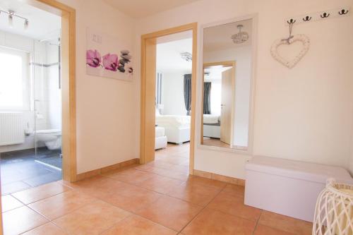 a bathroom with a toilet and a mirror at Rust-Fewo-Hotel in Rust